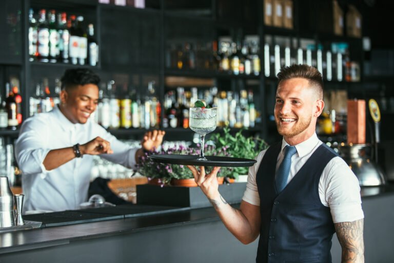 Smiling,Elegant,Waiter,Is,Holding,A,Tray,With,A,Decorated